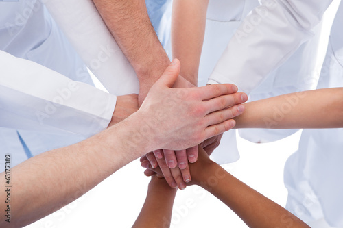 Doctors and nurses stacking hands