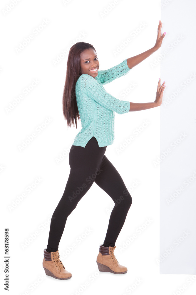 Confident African American woman pushing billboard Confident African American woman pushing billboard