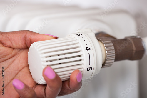 Woman Adjusting Thermostat