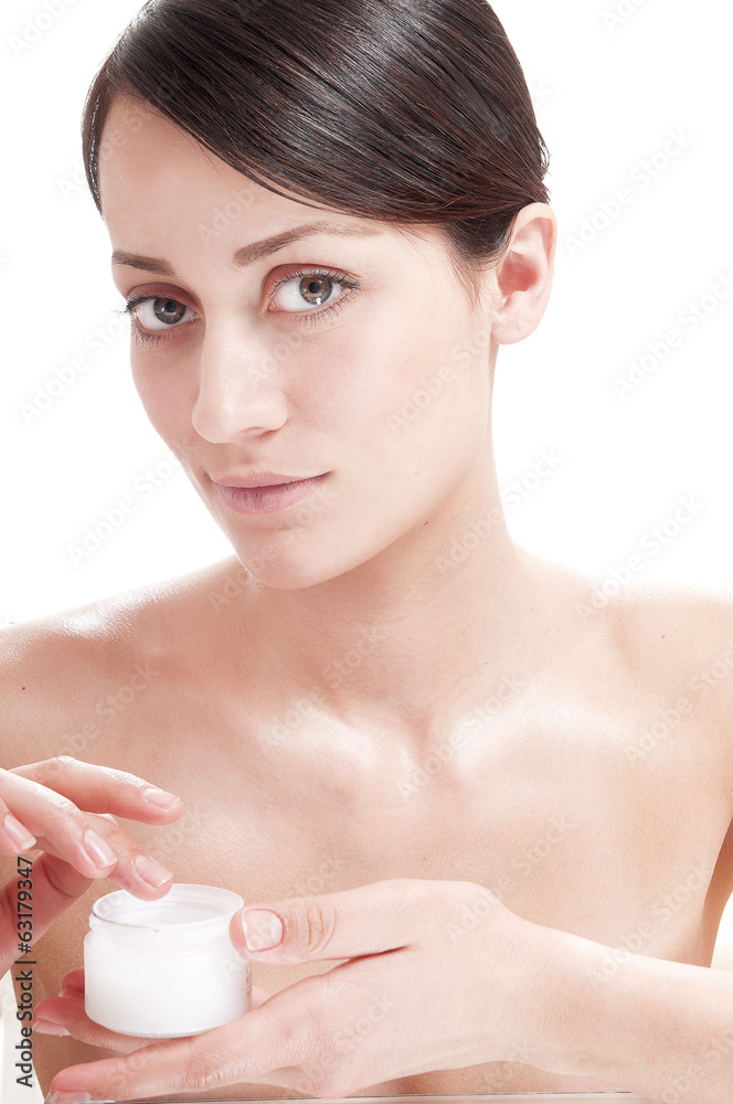 Beautiful woman applying cosmetic cream treatment on her face. Beautiful woman applying cosmetic cream treatment on her face.