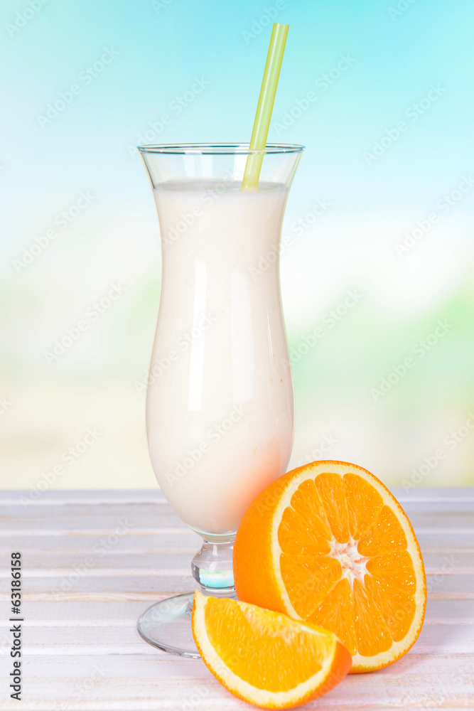 Milk shake on table on light blue background Milk shake on table on light blue background
