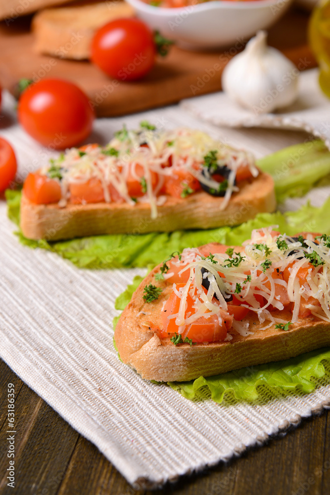 Delicious bruschetta with tomatoes on table close-up Delicious bruschetta with tomatoes on table close-up