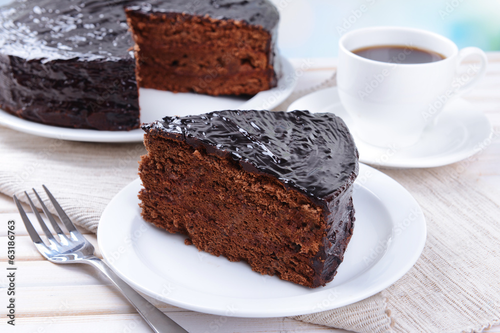 Delicious chocolate cake on plate on table close-up Delicious chocolate cake on plate on table close-up