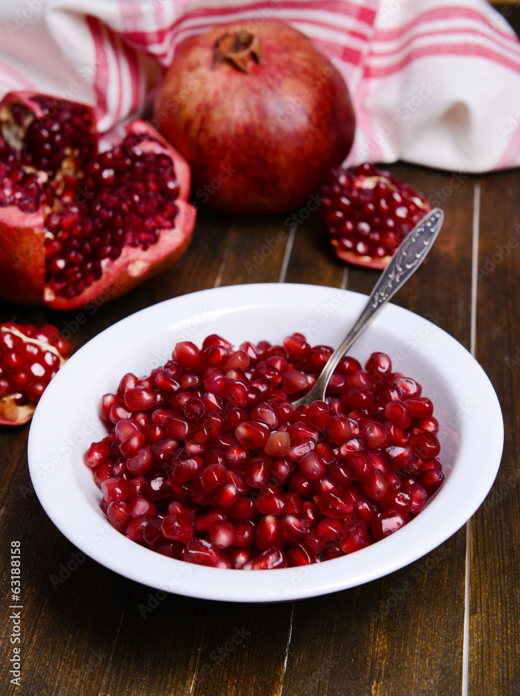 Ripe pomegranates on table close-up Ripe pomegranates on table close-up