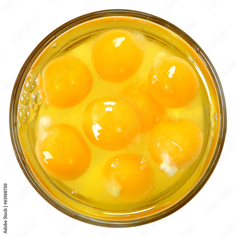 Raw Eggs in Glass Bowl Over White Raw Eggs in Glass Bowl Over White