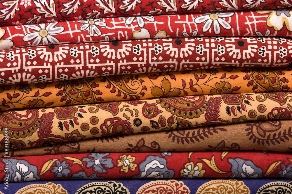 Heap of cloth fabrics at a local market in India. Close up . Heap of cloth fabrics at a local market in India. Close up .