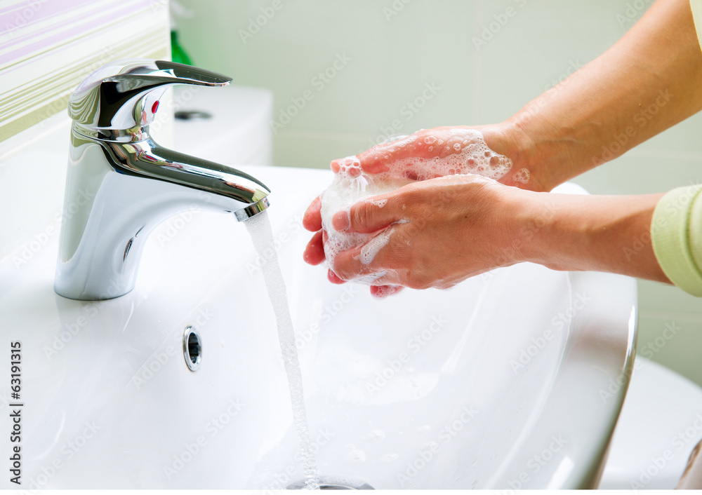Washing Hands with Soap. Woman Cleaning Hands in a Bathroom Washing Hands with Soap. Woman Cleaning Hands in a Bathroom