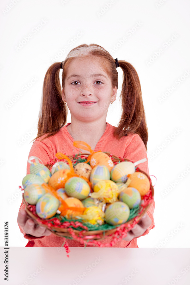young smiling freckles girl holding a basket of Easter eggs young smiling freckles girl holding a basket of Easter eggs