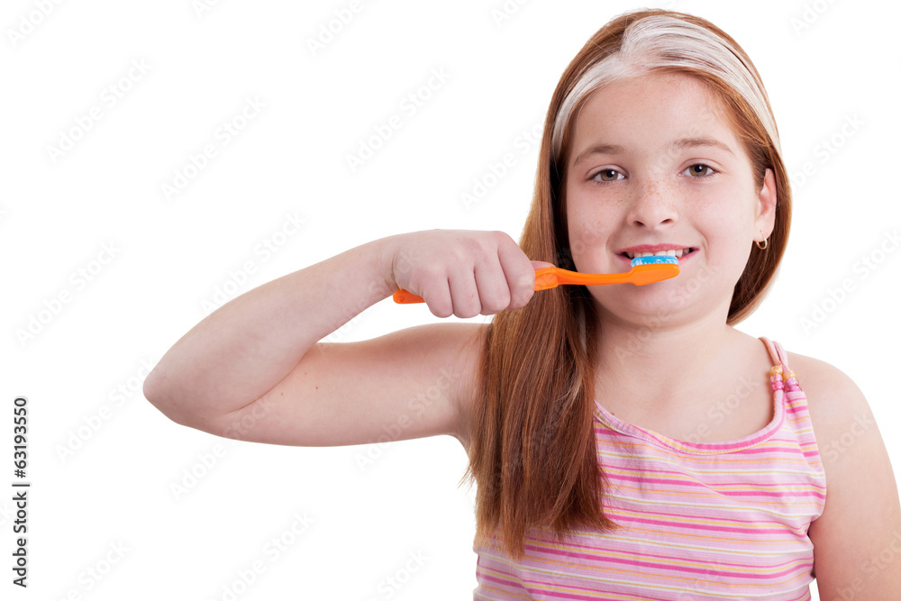 Smiling little girl with freckles brushing teeth Smiling little girl with freckles brushing teeth