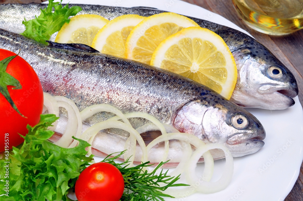 two rainbow trout with lemon and fresh vegetables two rainbow trout with lemon and fresh vegetables