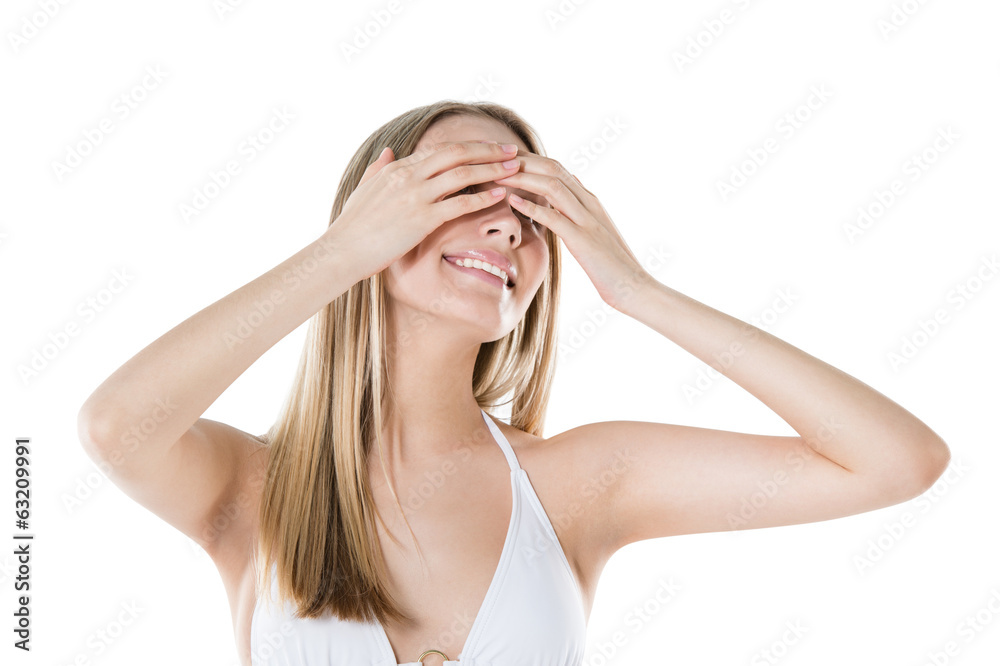 Woman hiding her eyes with hands and smiling isolated on white b Woman hiding her eyes with hands and smiling isolated on white b