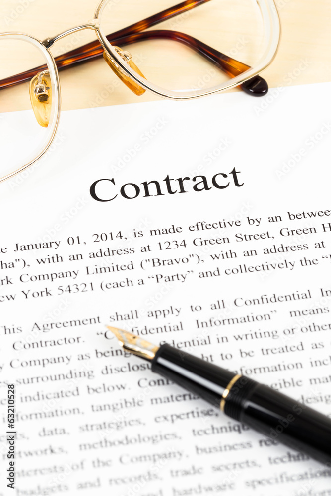 Business contract document with pen and glasses Business contract document with pen and glasses