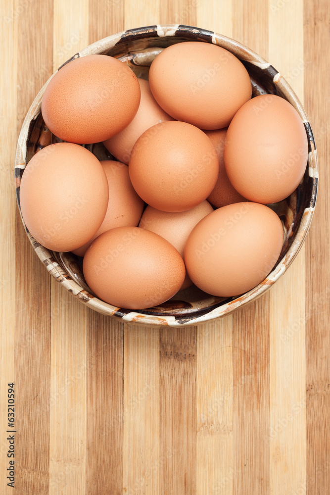 Chicken eggs in a traditional ceramic bowl Chicken eggs in a traditional ceramic bowl