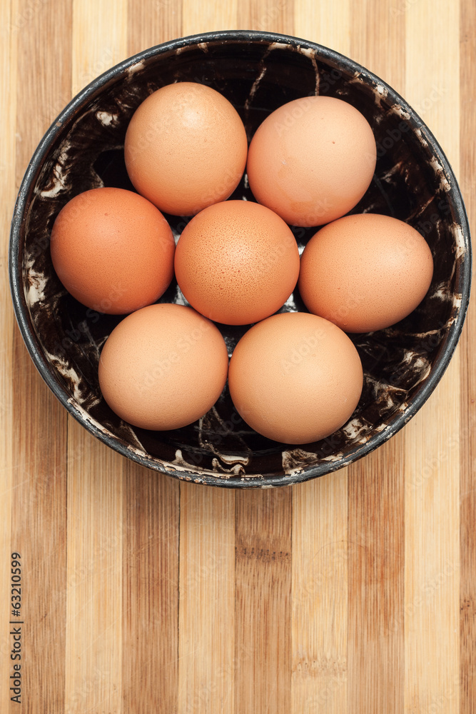 Chicken eggs in a traditional ceramic bowl Chicken eggs in a traditional ceramic bowl