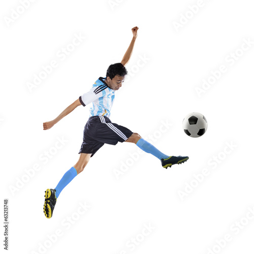 Football player kicking ball isolated © Creativa Images