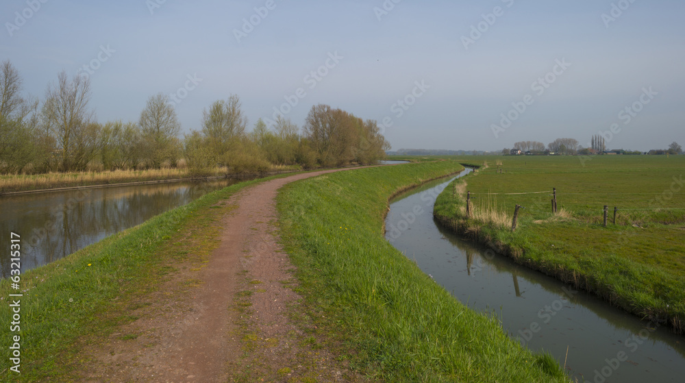 Dike meanders through a river in spring