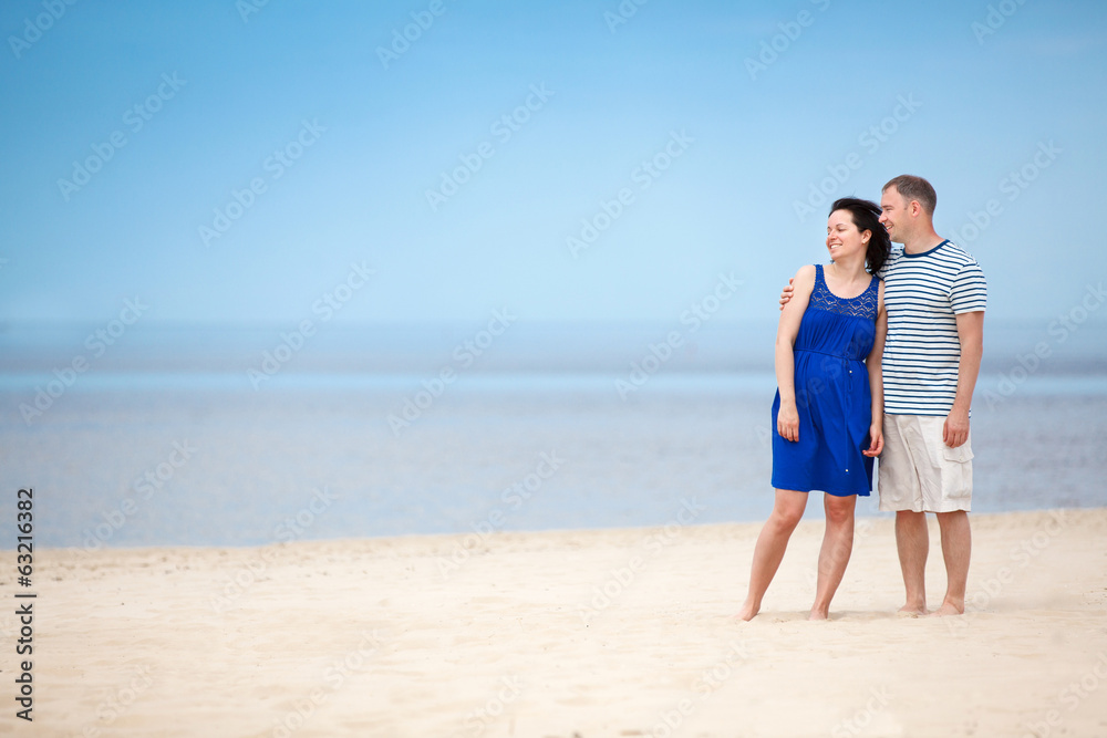 Young couple at tropical beach on summer vacation