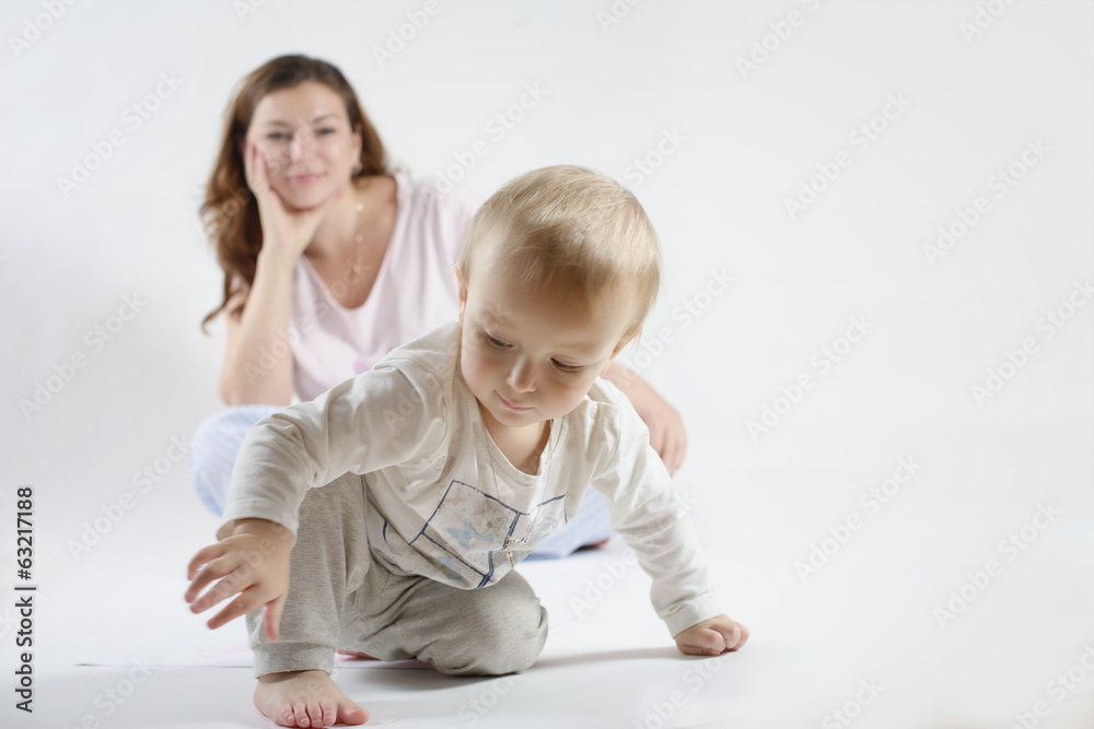 Mommy is looking in background at a playing child Mommy is looking in background at a playing child