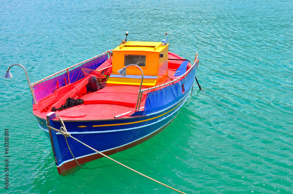 Traditional greek fishing boat painted in bright colors