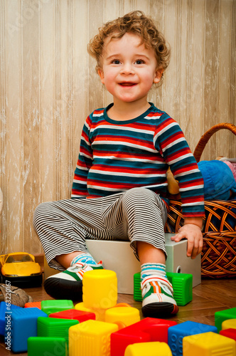 little boy playing with cubes