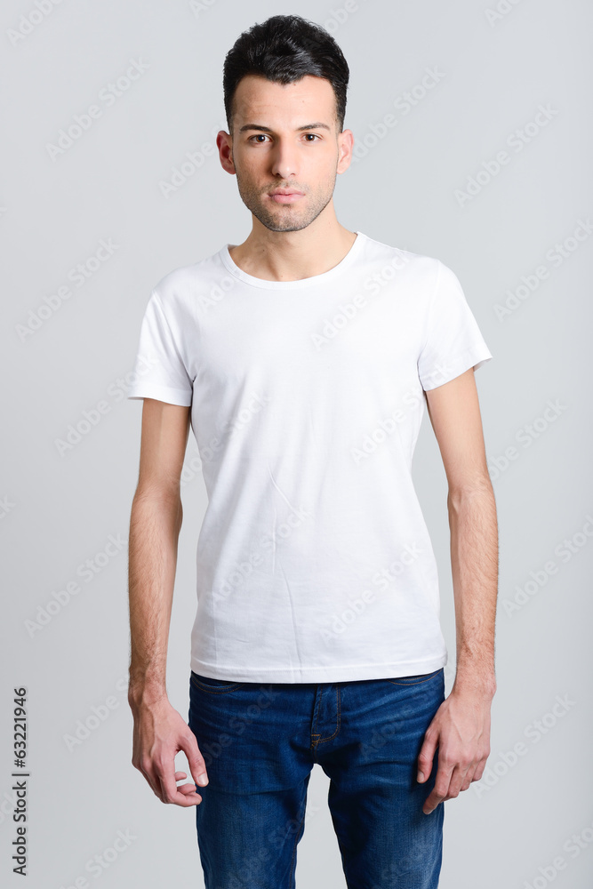 Serious young man standing against white background Serious young man standing against white background