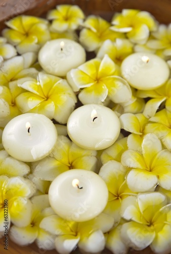 wooden bowl in many white and yellow frangipani