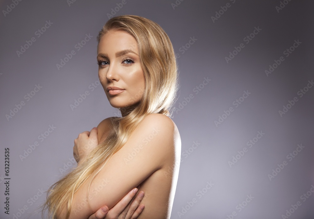 Nude young woman covering her breast with hands Nude young woman covering her breast with hands