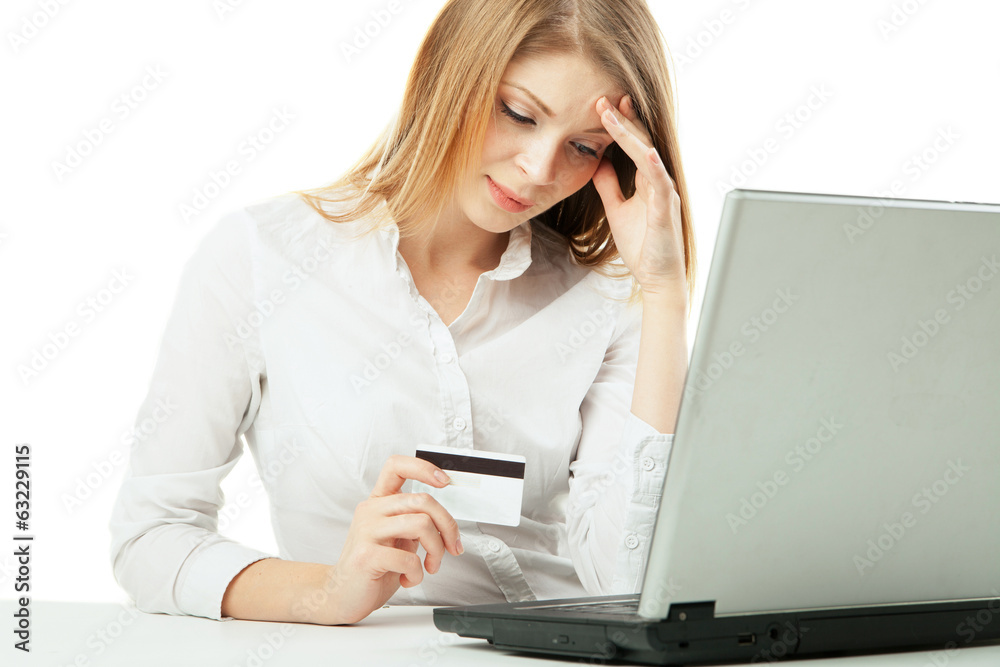 Shoked businesswoman with laptop and credit card Shoked businesswoman with laptop and credit card
