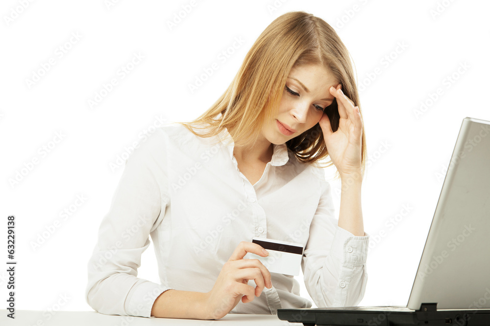 Shoked businesswoman with laptop and credit card Shoked businesswoman with laptop and credit card