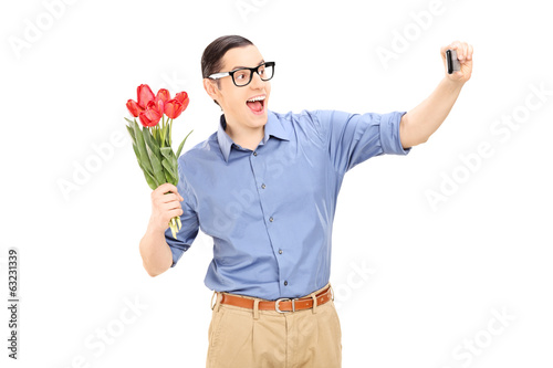 Man holding flowers and taking a selfie