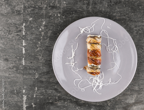 sushi with smoked eel in gray plate on old wooden table