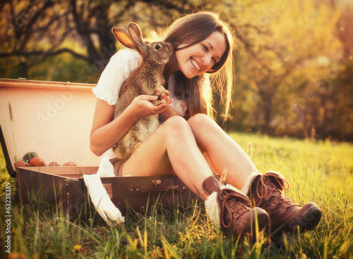 Canvas Print Vintage style photo from a beautiful young woman with her bunny