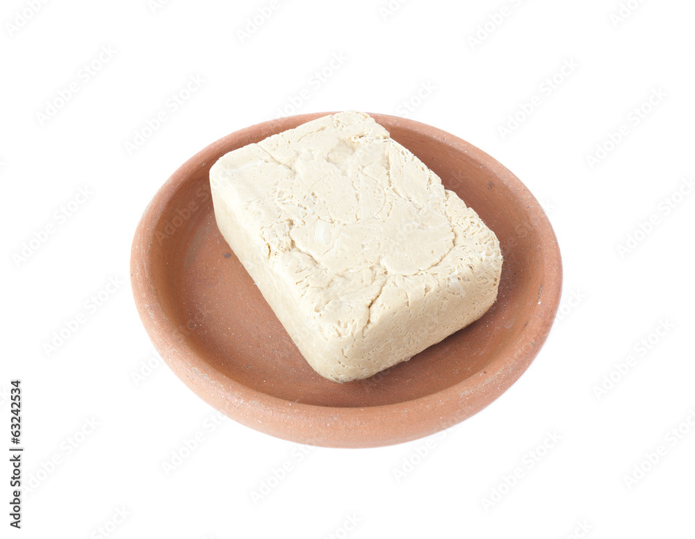 Halva with peanuts in bowl of clay isolated over white