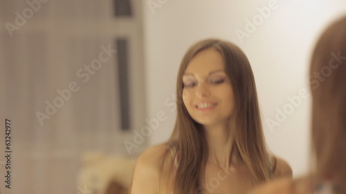 Girl dances and sings before the mirror Full HD 1080 NTSC photo