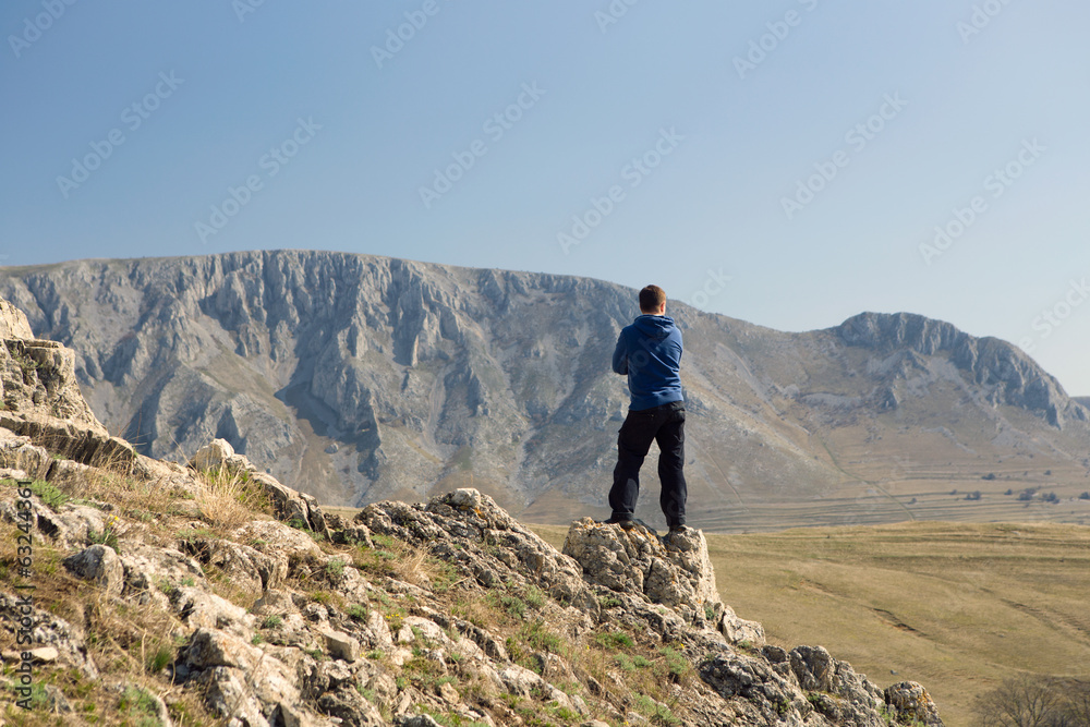 Man standing on top of mountain