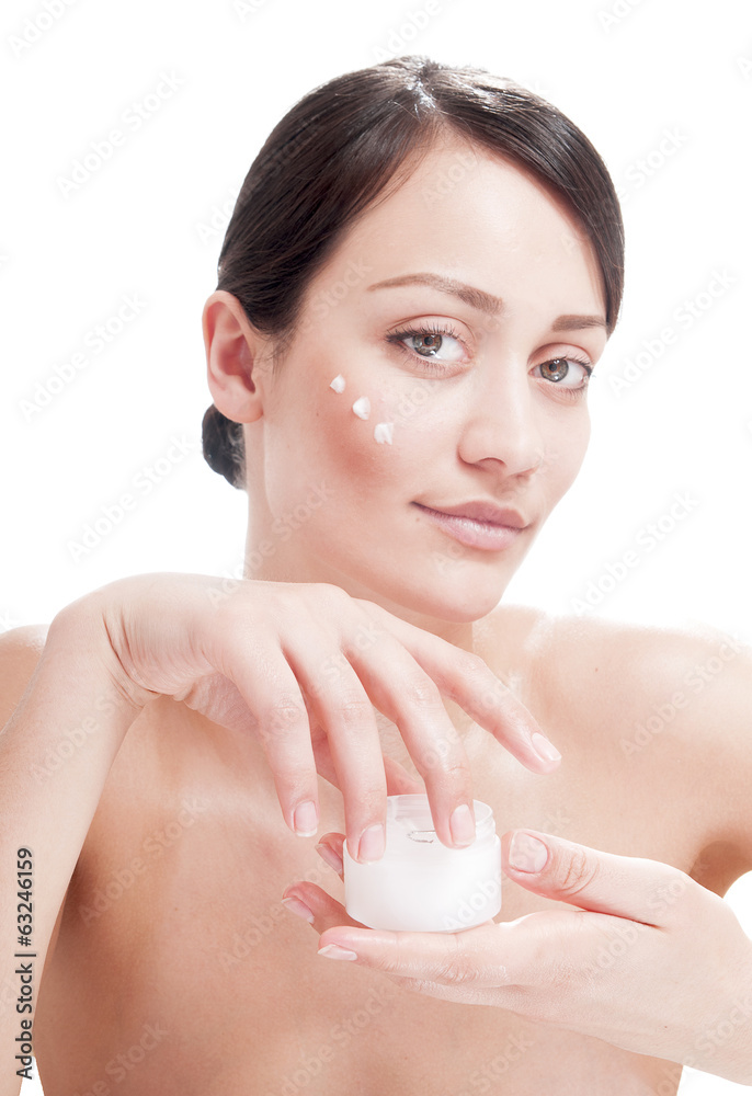 Beautiful woman applying cosmetic cream treatment on her face. Beautiful woman applying cosmetic cream treatment on her face.