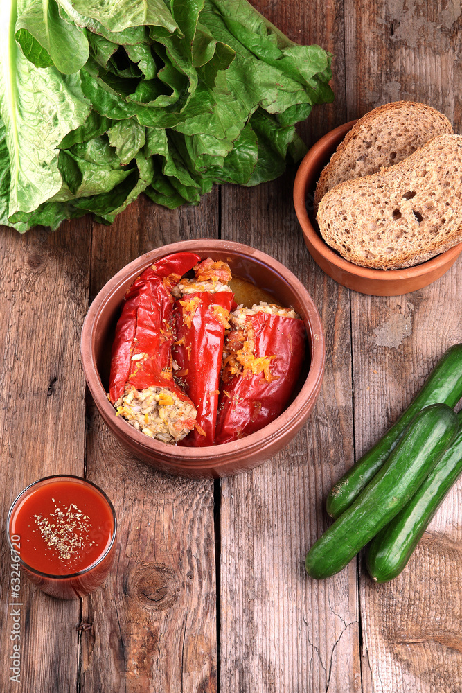 Baked red peppers with meat and rice.Black bread,vegetables and Baked red peppers with meat and rice.Black bread,vegetables and