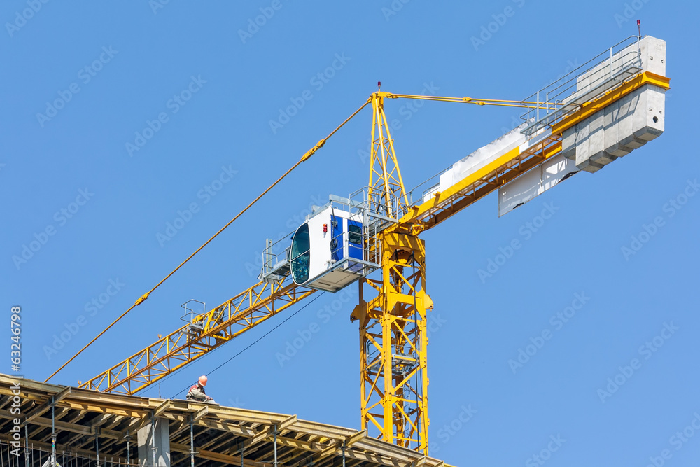 Crane on construction site over blue sky