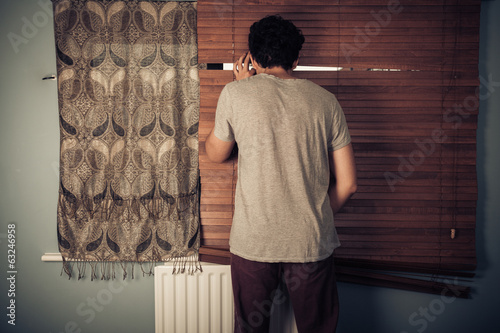 Fotografija Peeping tom looking through blinds