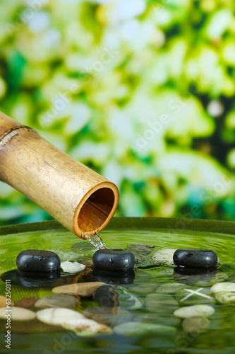 Spa still life with bamboo fountain  on bright background