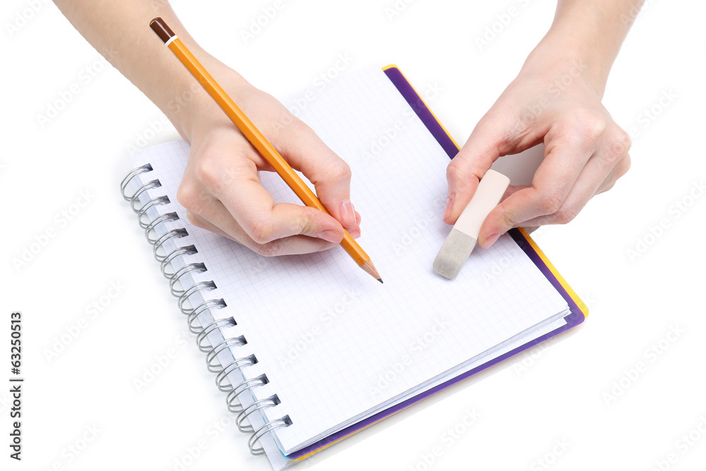 Human hands with pencil and erase rubber and notebook, isolated Human hands with pencil and erase rubber and notebook, isolated