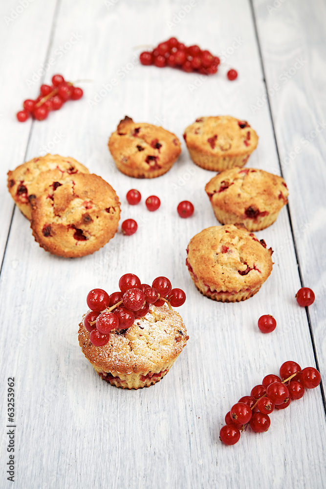 Muffin with red currants on a white wooden table Muffin with red currants on a white wooden table