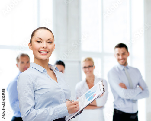young smiling businesswoman with clipboard and pen