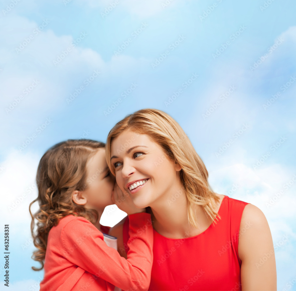 smiling mother and daughter whispering gossip smiling mother and daughter whispering gossip
