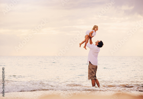 Father and Daughter Playing Together at the Beach at Sunset