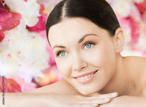 smiling woman in spa lying on the massage desk