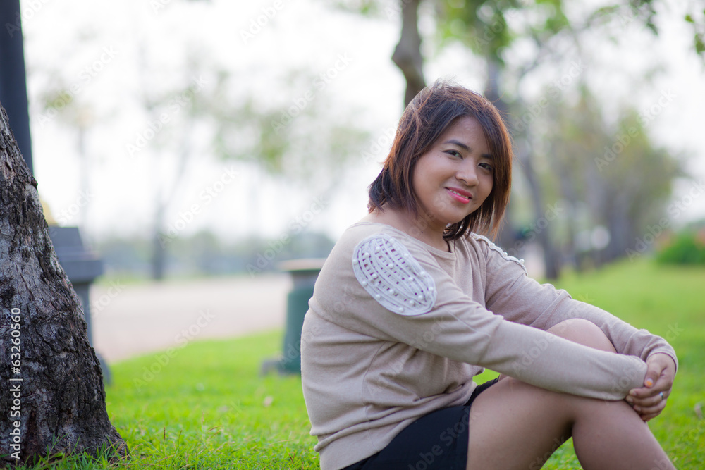 Portrait Asian woman sitting in the park. Portrait Asian woman sitting in the park.