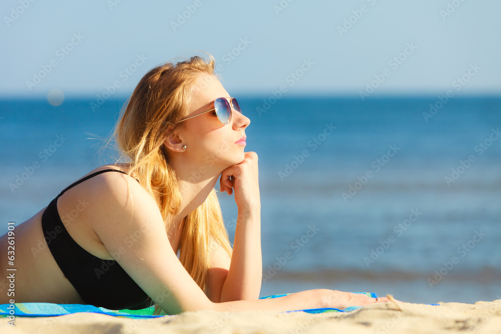Summer vacation Girl in bikini sunbathing on beach Summer vacation Girl in bikini sunbathing on beach