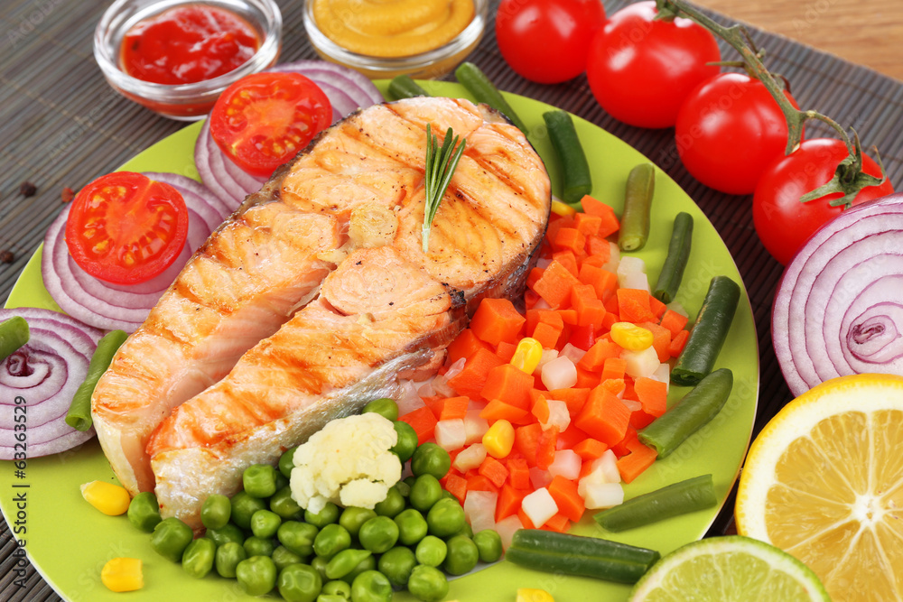Tasty grilled salmon with vegetables, close up Tasty grilled salmon with vegetables, close up