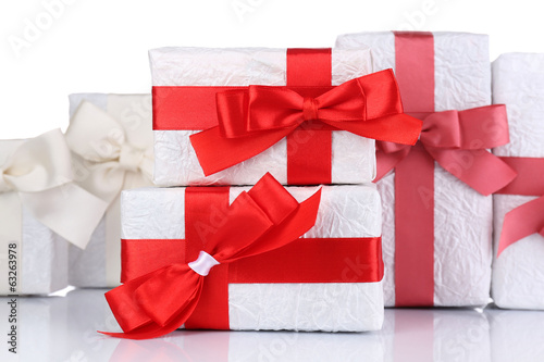 Beautiful gifts with red ribbons, isolated on white